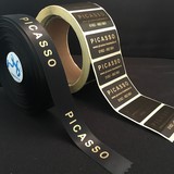 Promotiemateriaal kadolint Haarstudio Picasso zwart satijnen lint met goud glanzende bedrukking en stickers